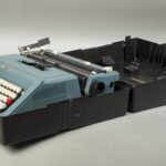 Blue typewriter in a black box