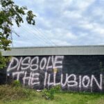 Graffiti which reads, 'Dissolve the illusion...'