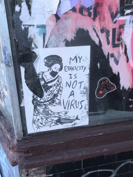 Stencil graffiti of woman which reads 'My ethnicity is not a virus'