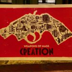 Outline of gun filled with machines early twentieth-century machines on a read background with the text Weapons of Mass Creation below