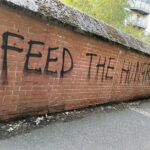 Graffi which reads "FEED THE HUNGRY"