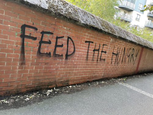 Graffi which reads "FEED THE HUNGRY"